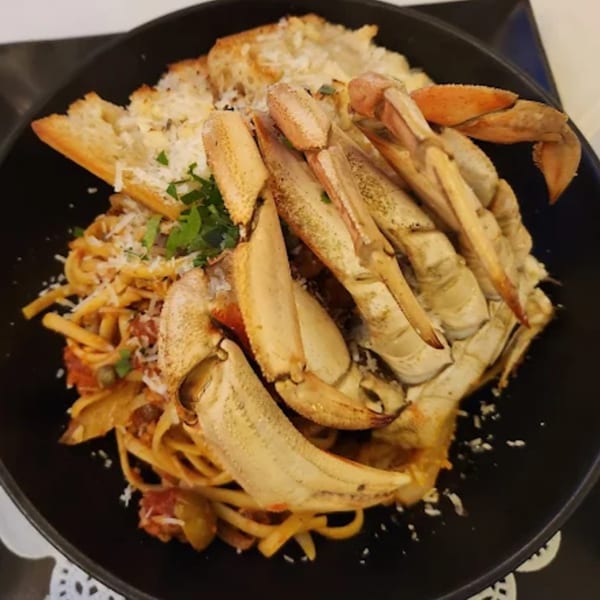 KW Saltwater Grill's crab pasta with linguine, tomato sauce, parmesan, and garlic bread.